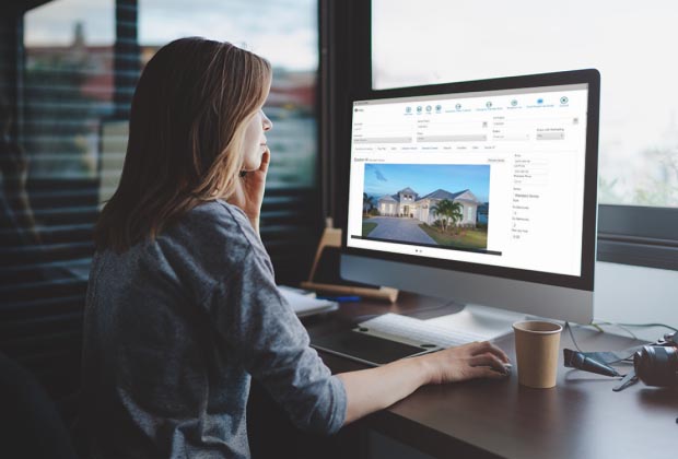 Lady on a computer looking at homes