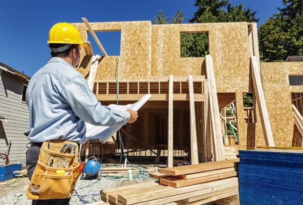 Construction manager standing in front of a construction site