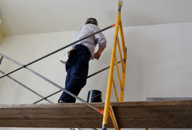 Painter on top of scaffolding