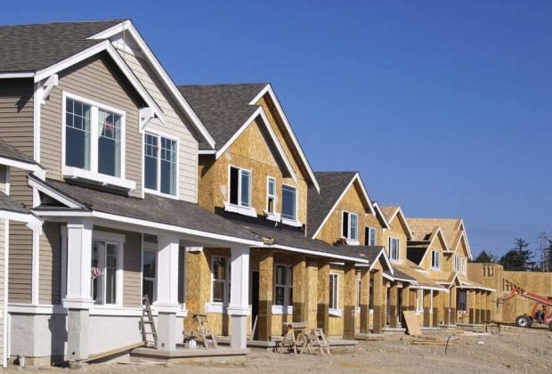 A construction site showing houses in a row under construction