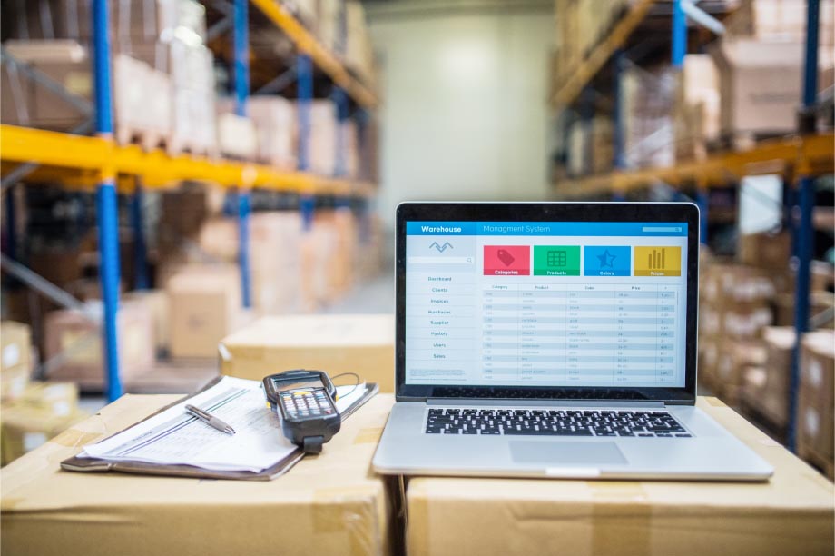 laptop on top of boxes in a warehouse.