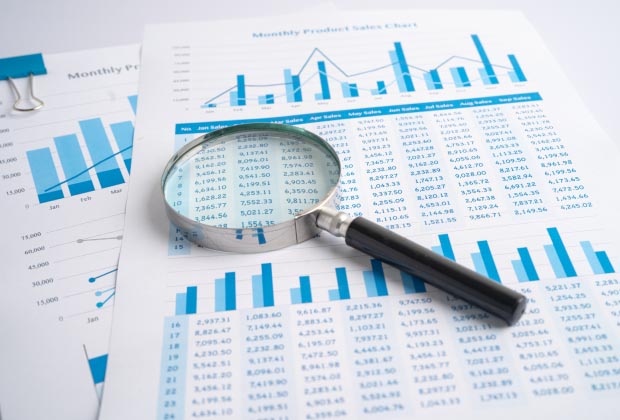 A magnifying glass over a monthly product safety chart