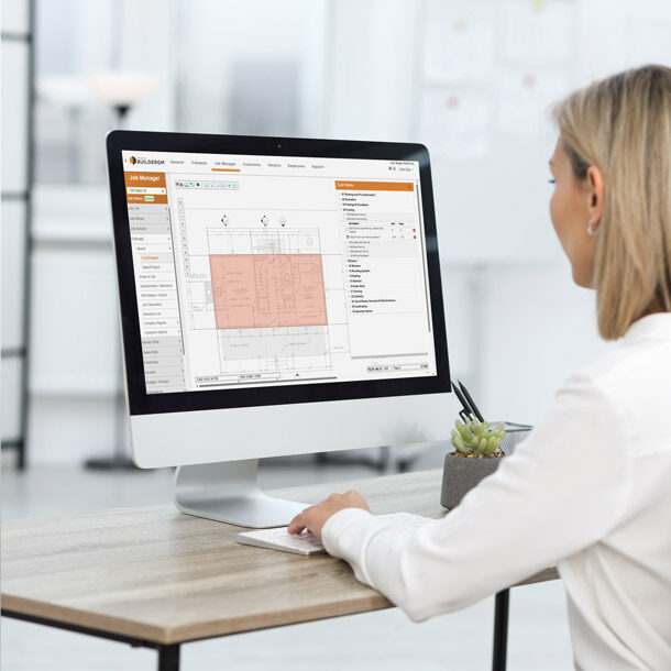 Woman using Hyphen BuilderGM software at a desk