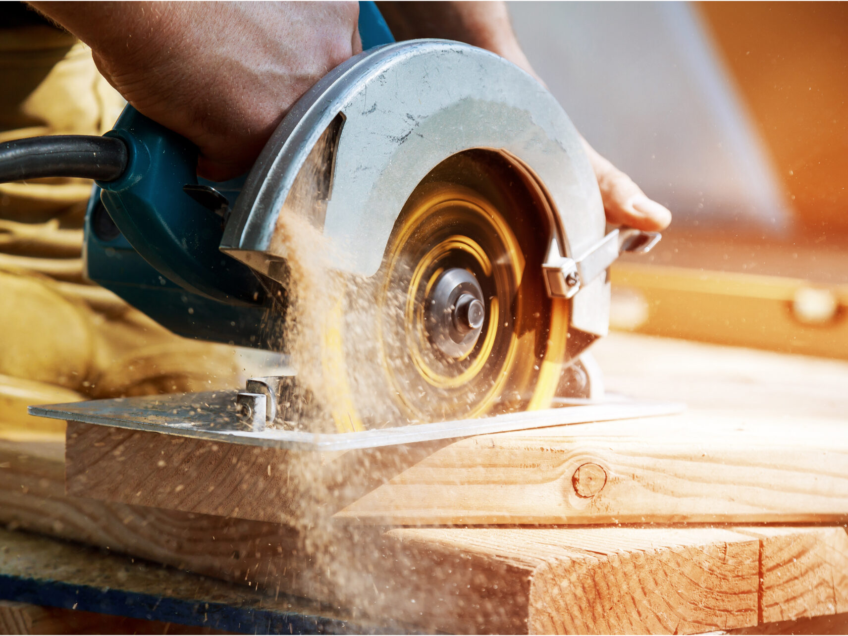 Construction worker cutting a piece of wood
