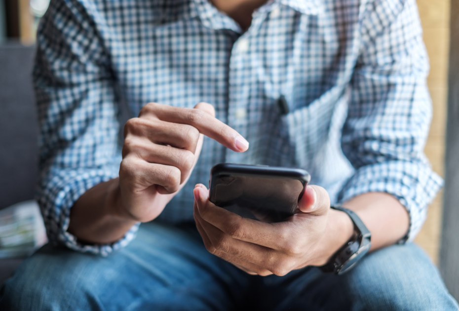 Man using phone and about to click on screen