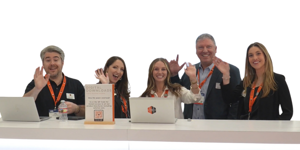 Team of 5 people from the Hyphen team smiling and waving