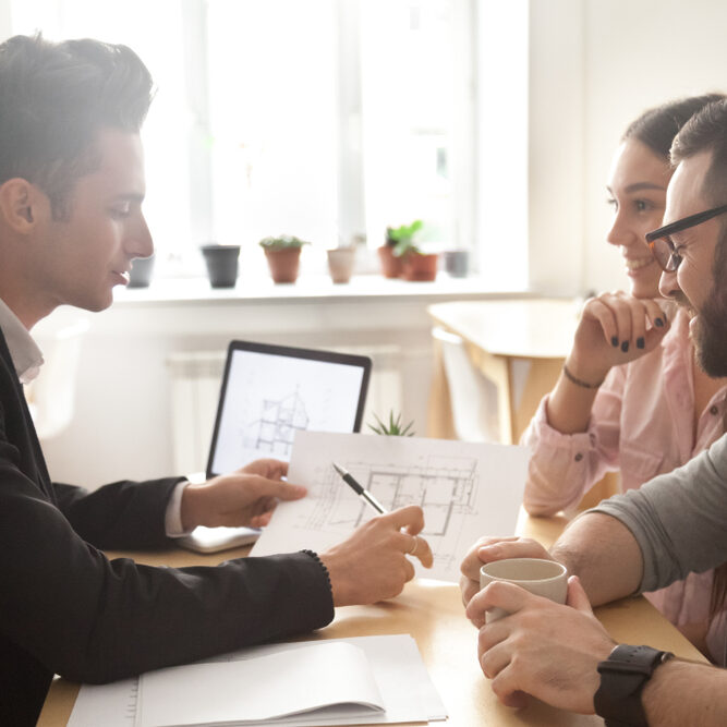 Man using Hyphen Builder GRM software and meeting with two people