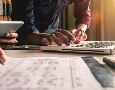Two people working collaboratively on their laptops